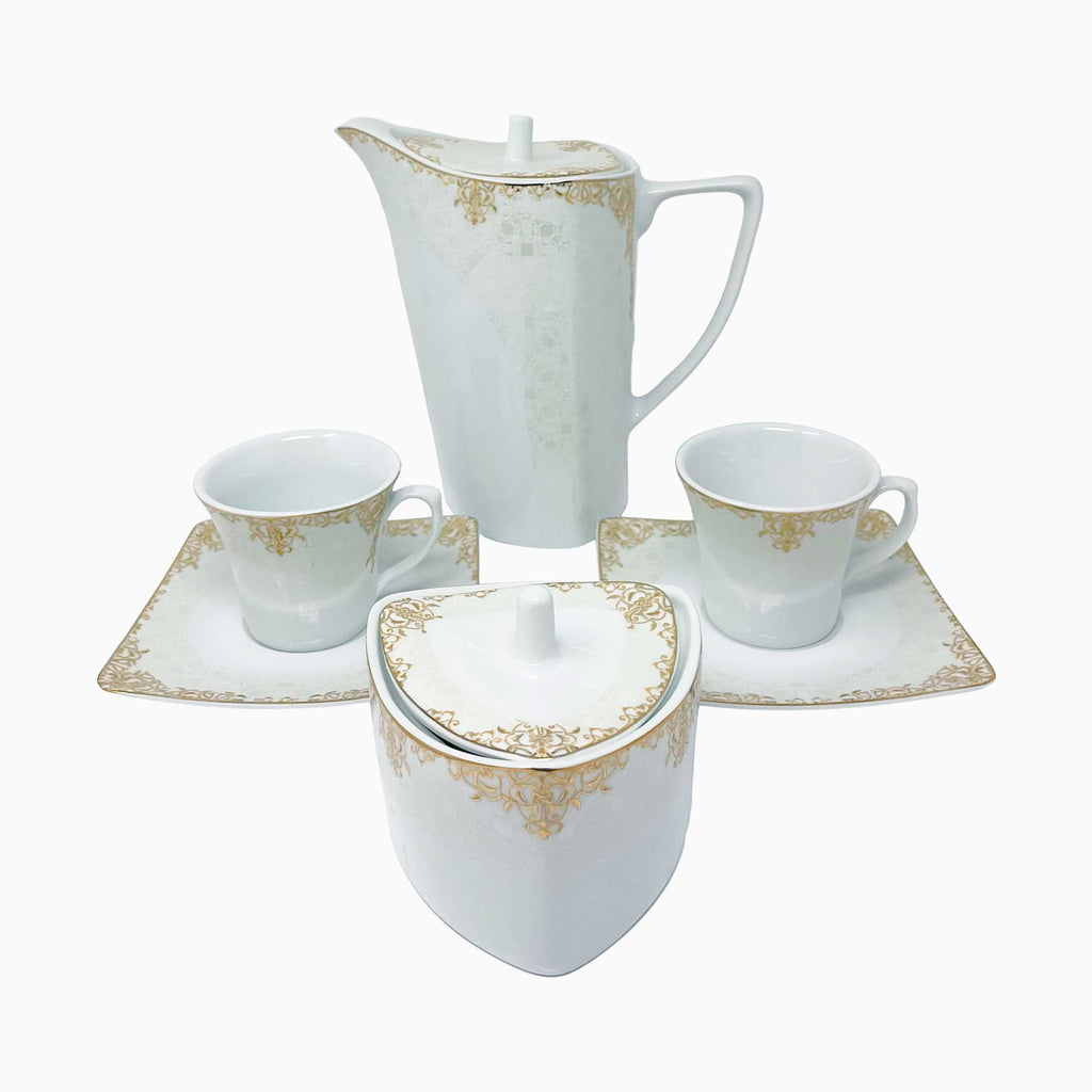 White ceramic tea set with gold accents