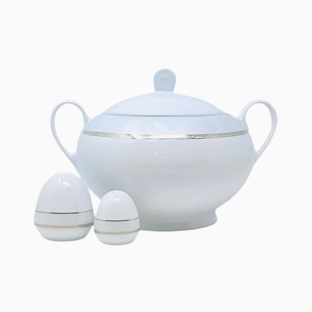 White ceramic bowl with lid and salt and pepper shakers on a white background
