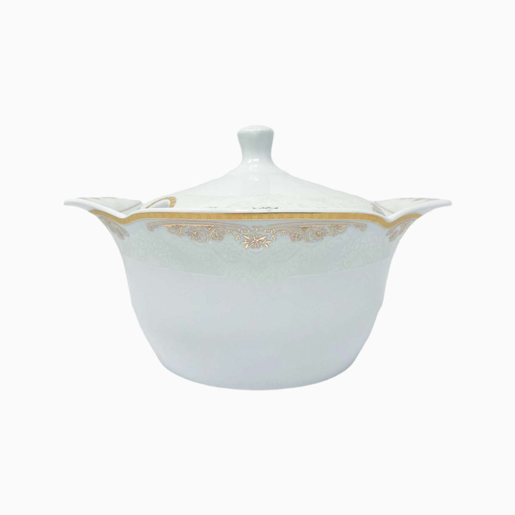 White ceramic tureen with gold accents on a white background