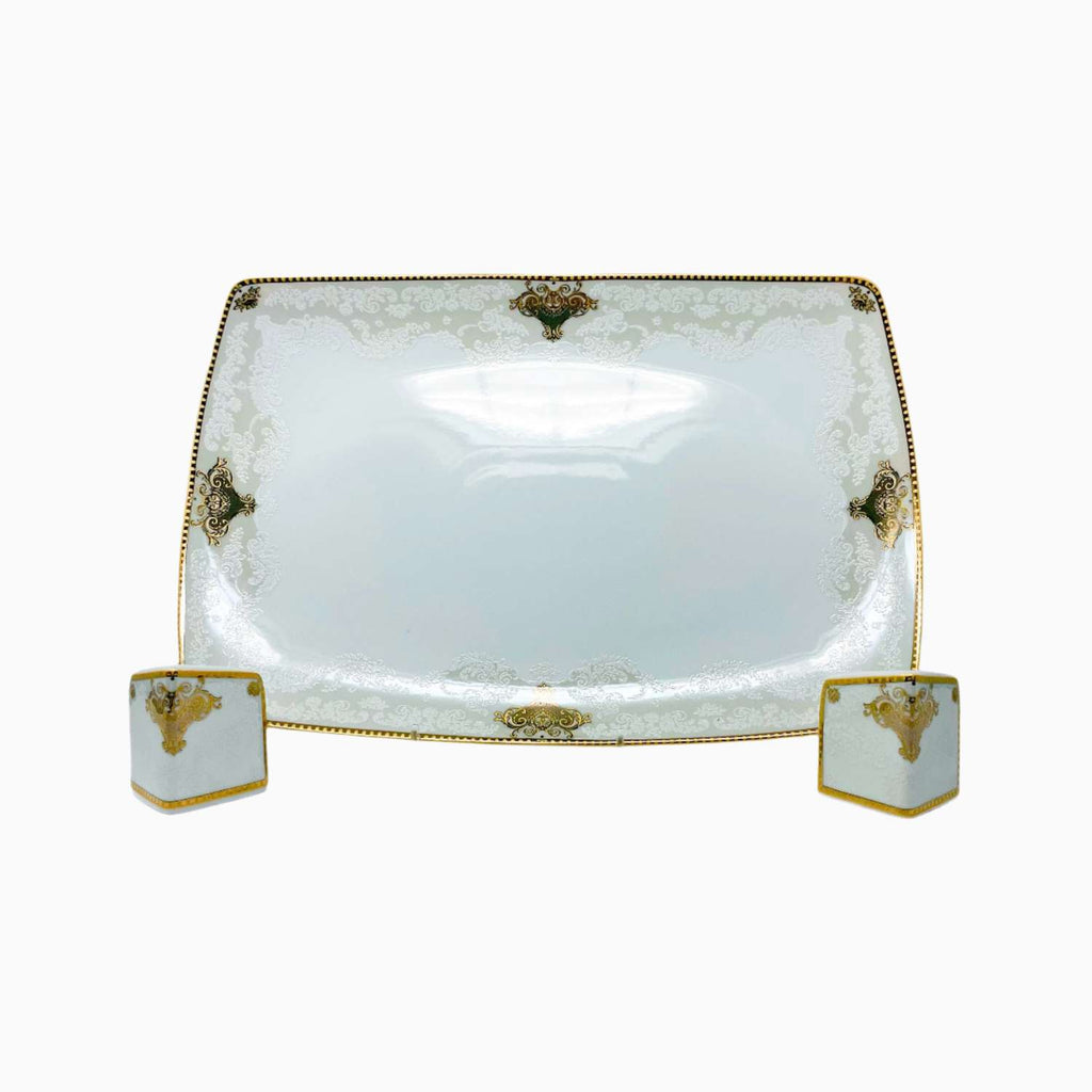 Decorative white dish with gold accents on a white background