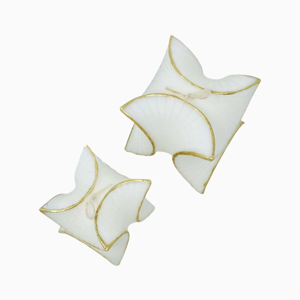 Pair of white butterfly-shaped CANDLES with gold edges on a white background