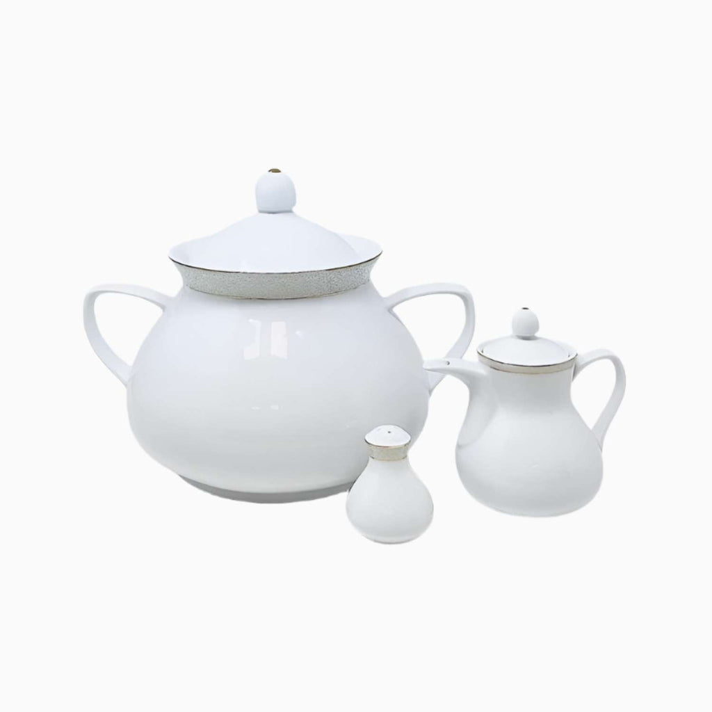 Set of white ceramic teapot, sugar bowl, and creamer on a white background