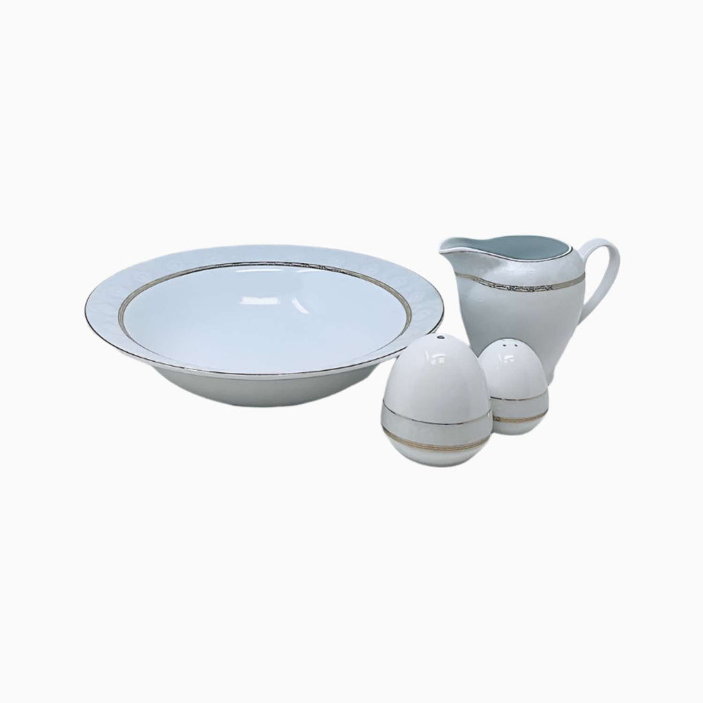 Ceramic bowl, pitcher, and salt and pepper shakers on a white background