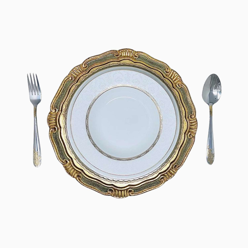 Decorative gold-rimmed plate with a fork and spoon on a white background
