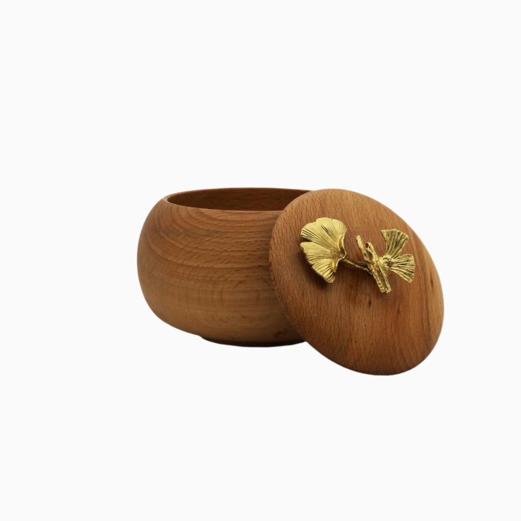 Wooden candy bowl with a gold ginkgo leaf design on a white background