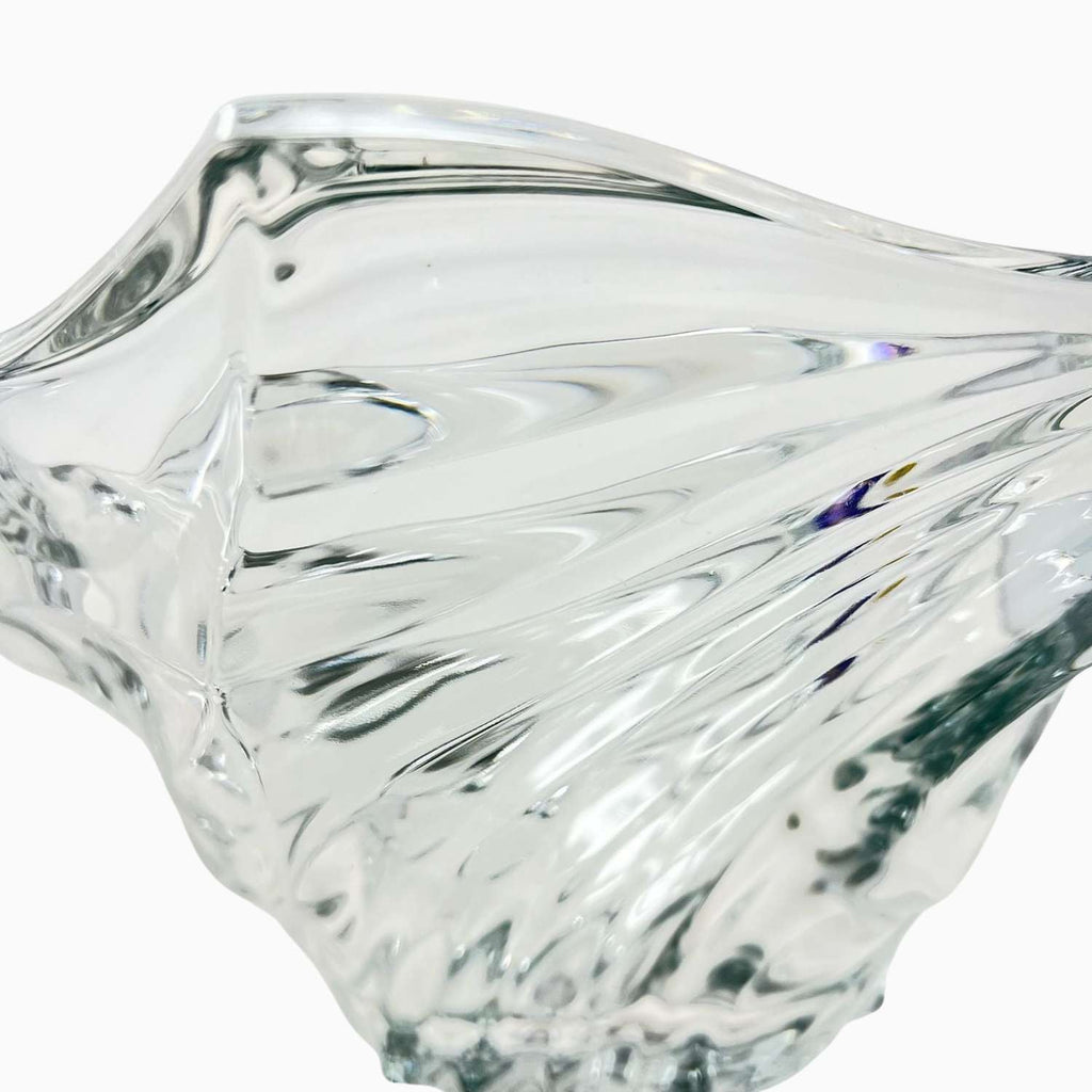 Clear glass bowl with wavy design on a white background
