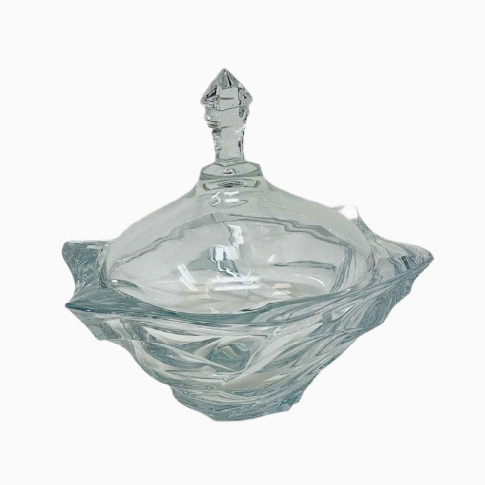 A clear glass candy bowl with a lid, featuring a textured design on the exterior.