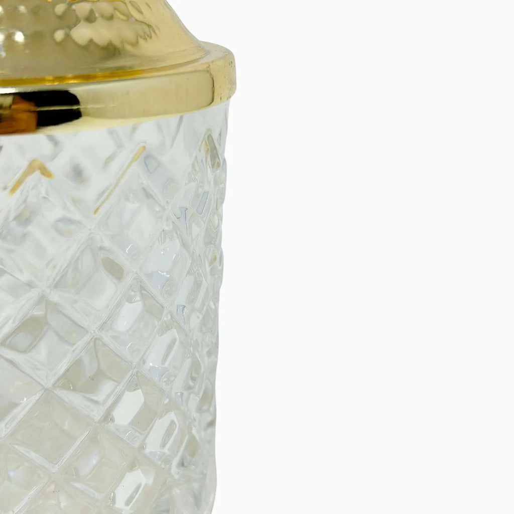 Gold round compact mirror with floral design on a white background