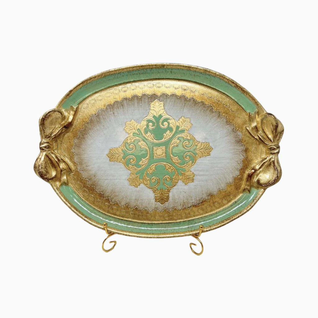 Decorative tray with gold and green design on a white background