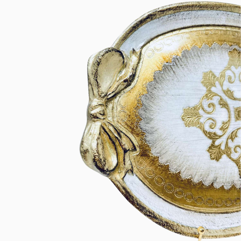 Decorative tray with gold rim and intricate design on a white background