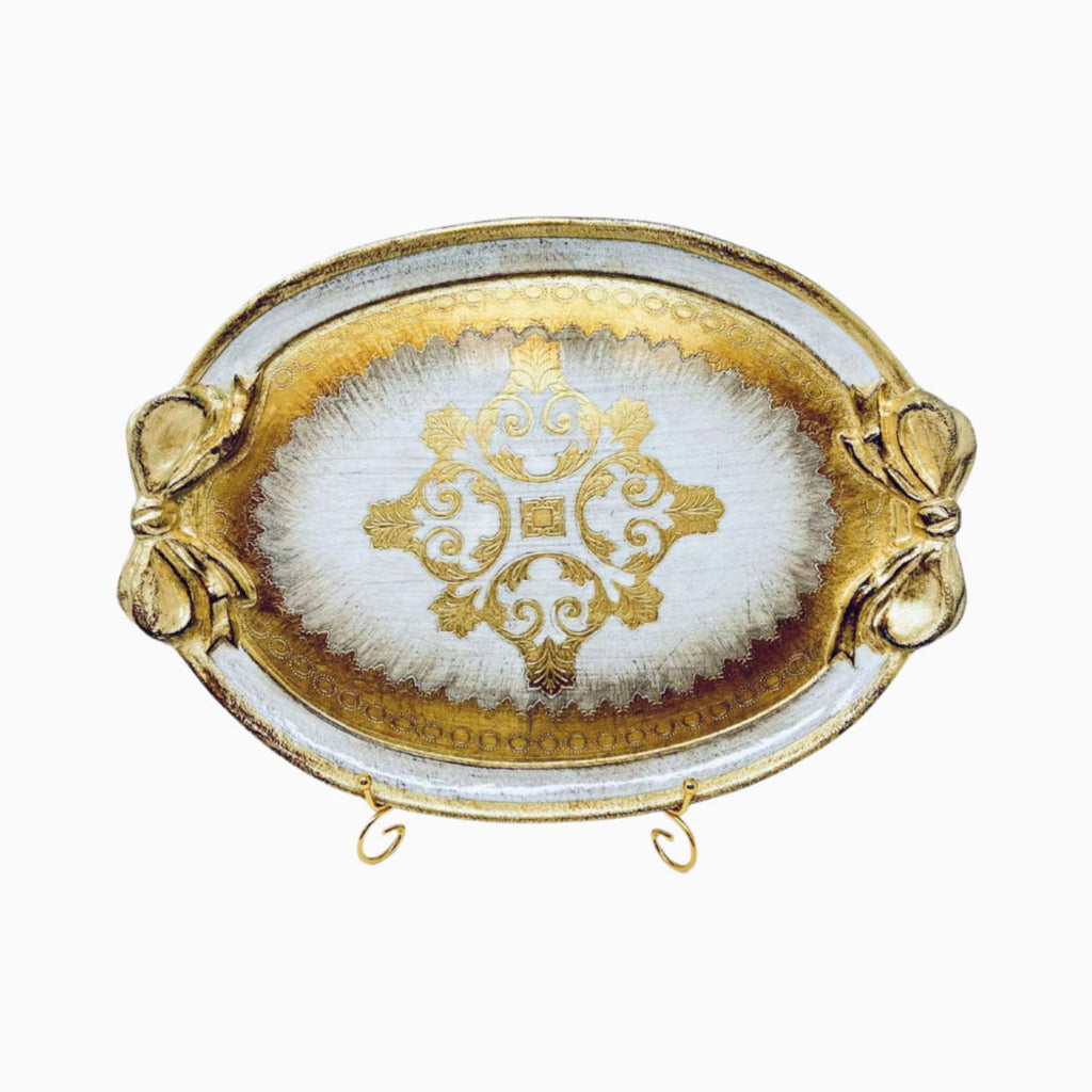 Decorative tray with gold rim and central design on a white background