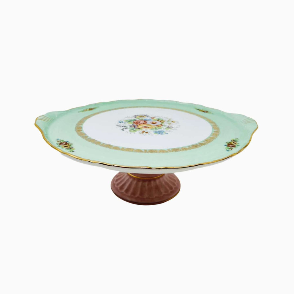 Decorative cake stand with floral design on a white background