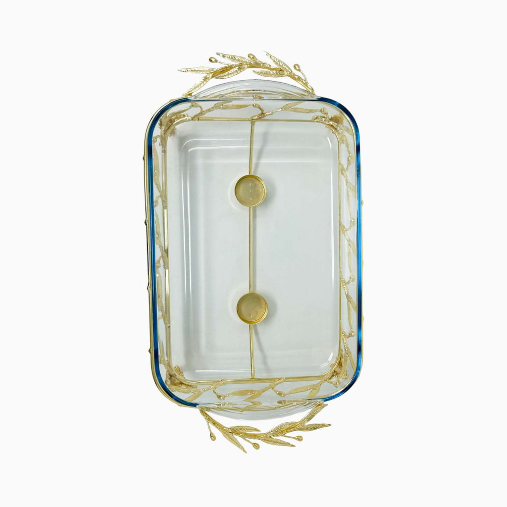 Decorative glass dish with gold leaf design on a white background