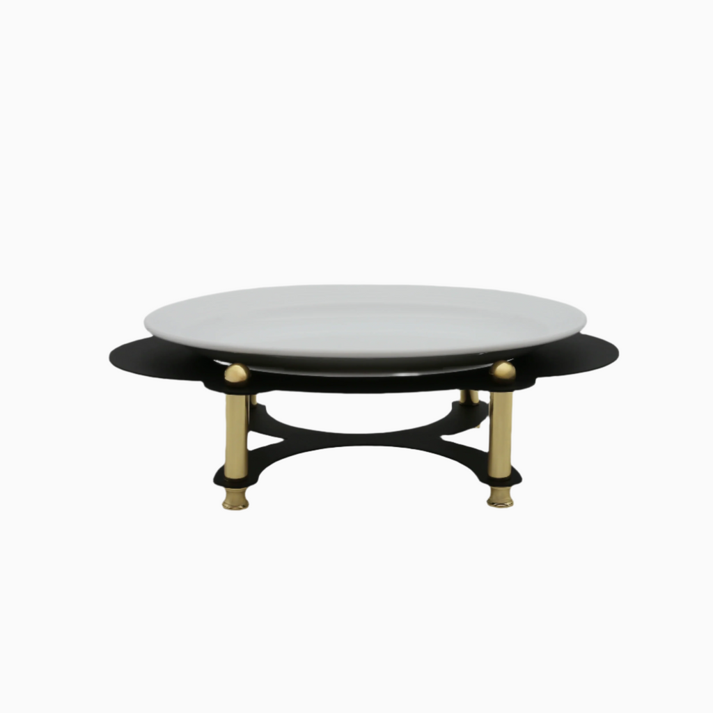 An oval serving plate with a white porcelain top on a black and gold stand with curved legs.