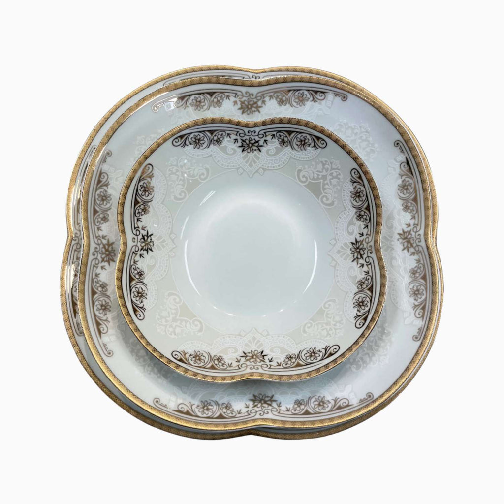 Decorative ceramic plate with gold and brown floral patterns on a white background