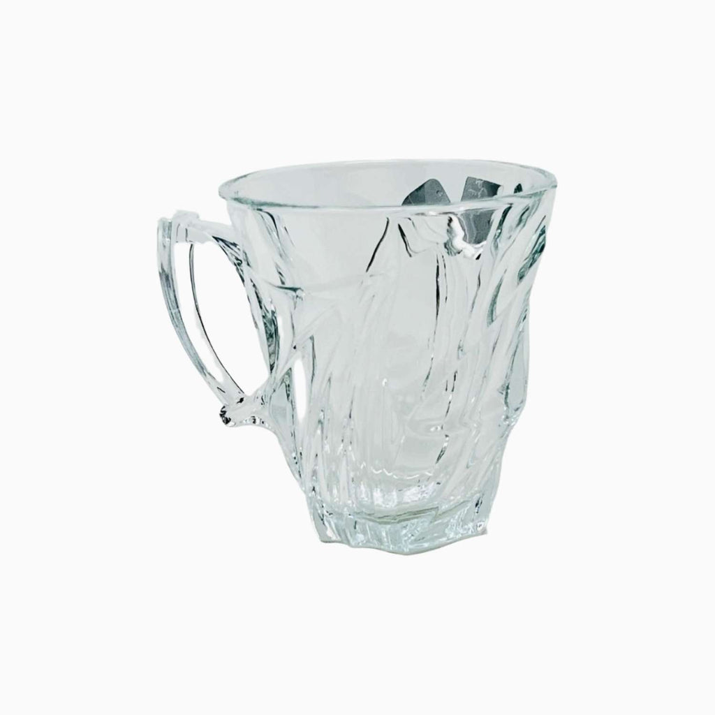 Clear glass mug with decorative handle on a white background